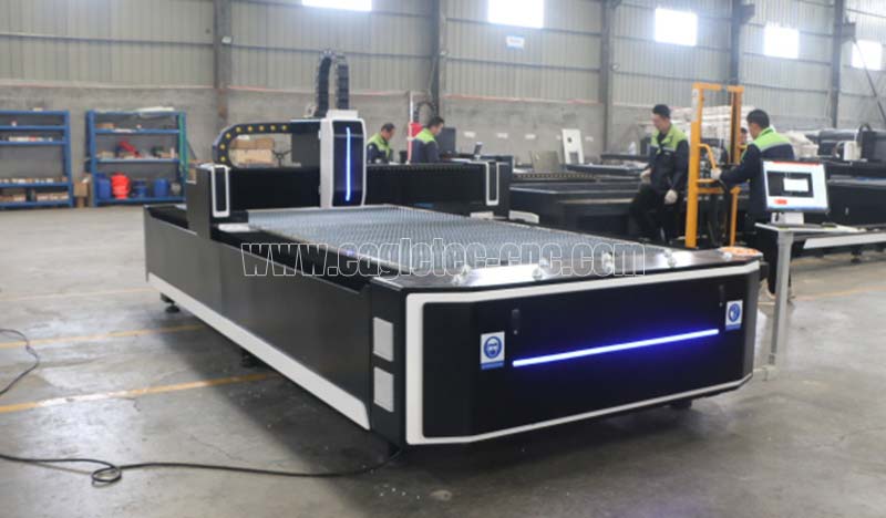 black fiber laser metal cutting machine in the workshop with light on