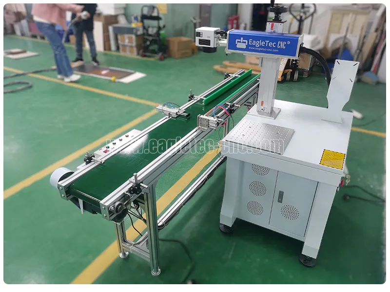 qr code laser marking machine with a conveyer belt placed next to it